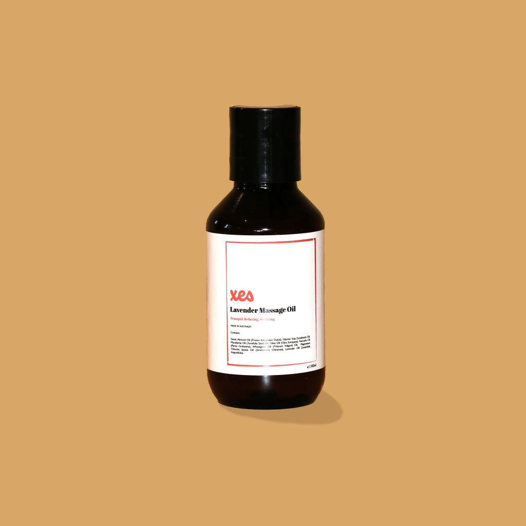 The XES Products massage oil. It is a 100ml amber bottle with a false wall push top that is black. The label reads XES Lavender massage oil tranquil relaxing soothing. The  XES Products lavender massage oil is enriched with magnesium to soothe muscles, decrease pain and decrease anxiety, 