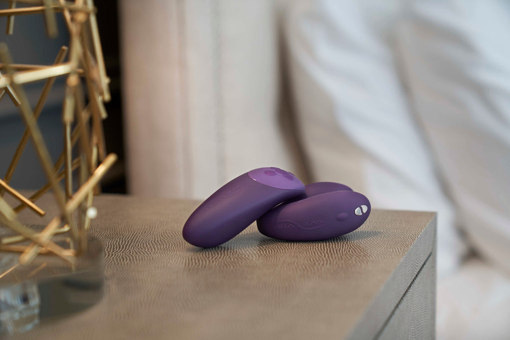 Lifestyle image of the Chorus by We-Vibe and Chorus remote on a bedside table. 