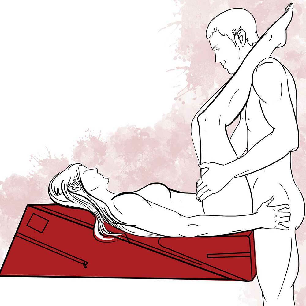 Illustration of two partners using the wedge ramp combo. The wedge is placed ontop of the ramp and a woman is lying on her back on the wedge ramp combo by Liberator. The partner is standing, with the female partners legs raised to his shoulders.