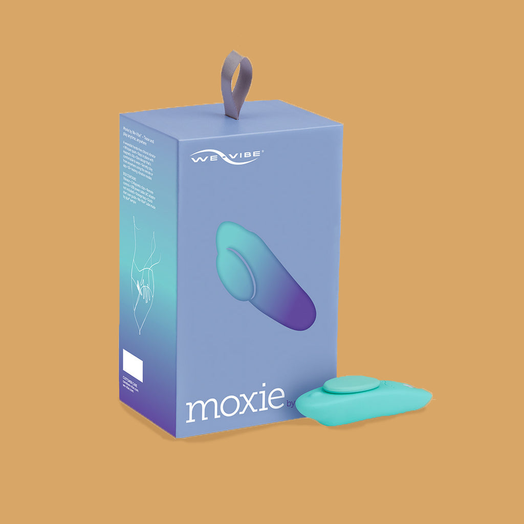 The Moxie by We-vibe and its packaging box. The box is blue. Moxie by We-Vibe. The Moxie is a blue vibrator that is oval shaped to fit nicely within the underwear, There are two buttons at the bottom of the hands-free vibrator. There is a circular magnet that sits in the upper third of the vibrator to securely set the moxie by we-vibe in place. Accessible and disability friendly sold at xesproducts.com.au xes products