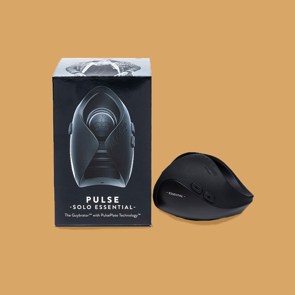 The hot octopuss pulse duo. The guybrator is black and can curve around the penis with two wings. The guybrater is slightly higher at the end. There is a plus and minus button on the side of the vibrator to change the vibration.  The packaging sitting next to the vibrator. 