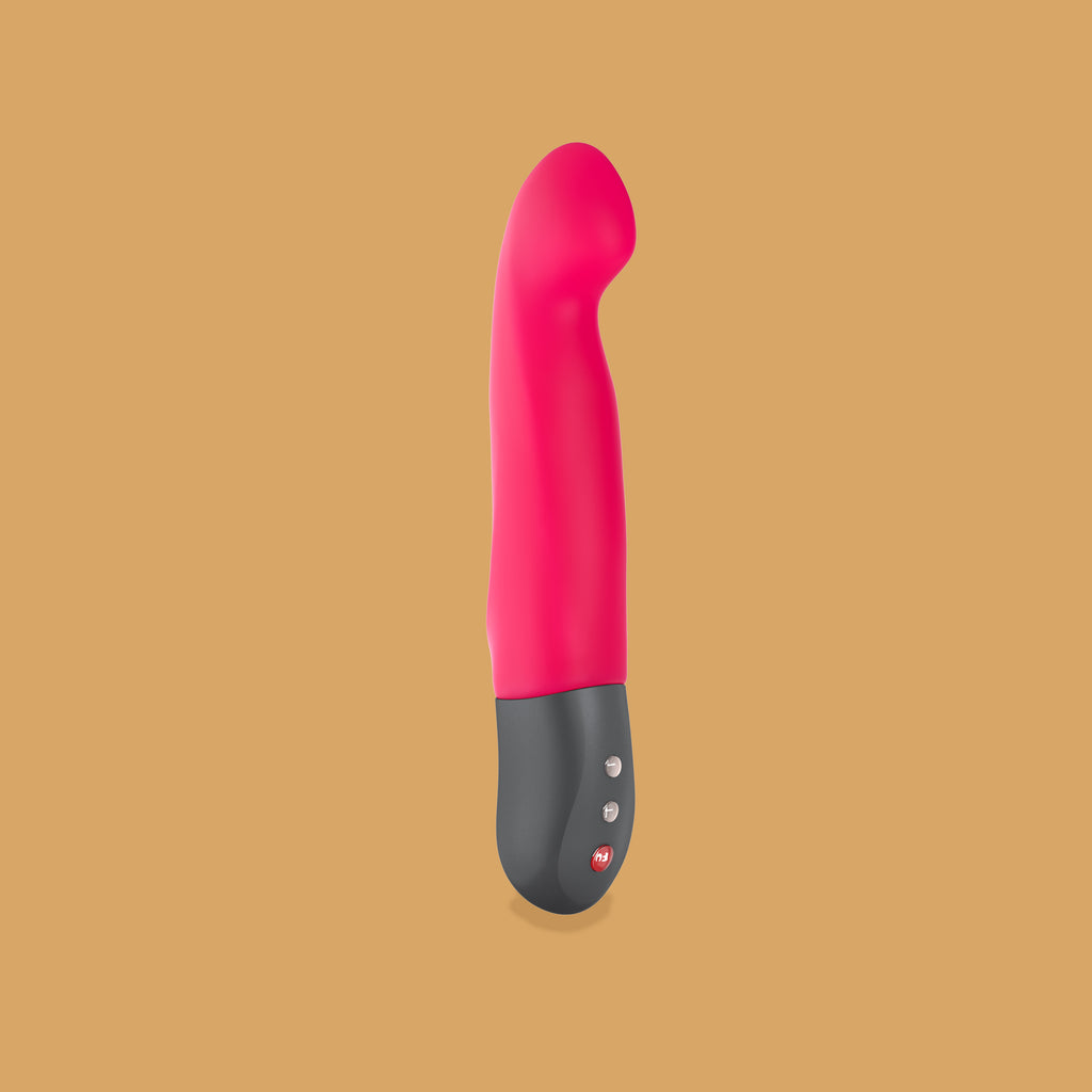 The Stronic-G by Fun Factory. The insertable part of the vibrator is pink. The bottom part of the vibrator (handle) is a grey silver and has three small buttons that can be pressed to turn on the vibrator and adjust the settings. At the top of the vibrator there is a little curve to aid in g spot sensation. 