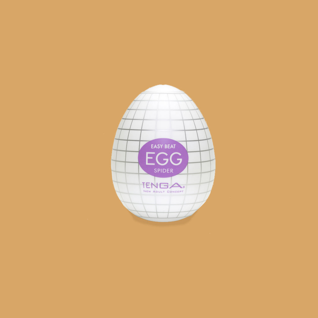 The Tenga Egg spider packaging. Looks like a hard boiled egg. Colour scheme purple. The spiders patterns looks like squares on a graph otherwise described as "ribbed spider web pattern"